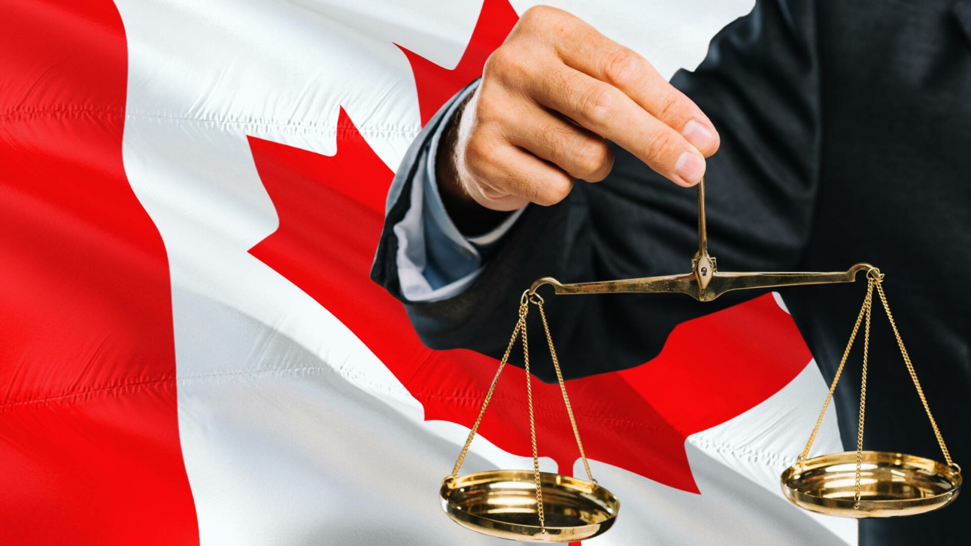 Close-up of a judge holding the scales of justice. The background is a Canadian flag, signifying the Canadian law.